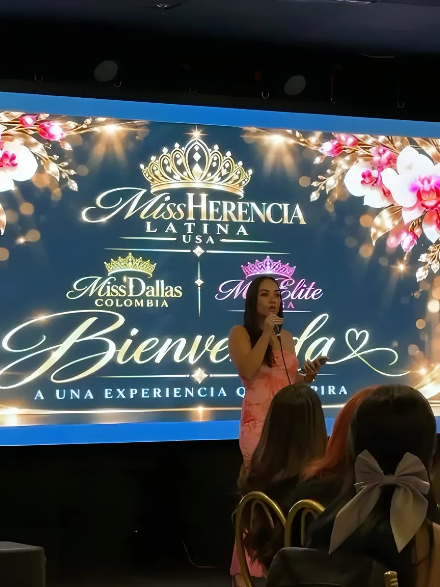A candidate addresses the audience in front of the welcome screen